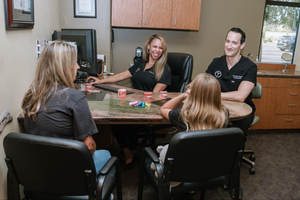 Dr. Teeters and his team talking to a family about Glendale orthodontics.
