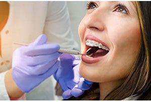 woman getting her braces examined